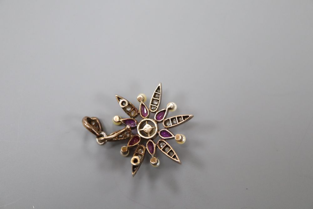 A late Victorian yellow metal, ruby, diamond and seed pearl set starburst pendant brooch, 33mm